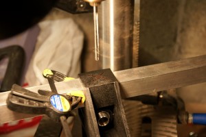 Drilling holes in the support brackets. You need to drill holes in the brackets for both the top and bottom tubes that run the length of each side of the trailer. If you use self-tapping screws rather than pop rivets, you don't need to drill.