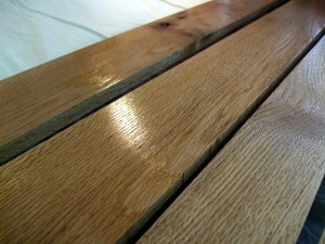I chose red oak for the trailer bed, largely because I had some lying around from a previous project. I planed it down to 5/8" to keep it light. If you‘re using a softer wood, you should keep it a bit thicker. Here, the slats are drying after a second coat of Varathane. Cedar would also be a good choice for the bed, as would a plain old sheet of exterior plywood. If you don't have a saw, you can take your trailer to Home Depot, have them cut a piece to size, and you can carry it home on your trailer to finish assembly. You can use pretty much any hard-wearing exterior finish here, including paint or tung oil. If you really want shine and a bullet-proof finish, try marine spar varnish. But it‘ll cost you.