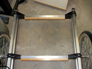The wooden crosspieces have been mounted to the frame and are ready for the slats to be fastened. I chose this design rather than attaching the slats directly to the aluminum crosspieces because it means that the entire bed is attached to the trailer frame with only six screws, greatly easing any future replacement or maintenance.