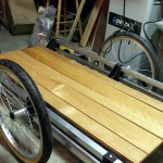 The oak slats, dry after a third coat of Varathane, get a dry fit before being secured to the trailer frame.