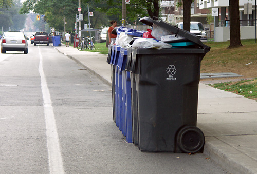 55 Cosburn Ave. puts its garbage in the bike lane