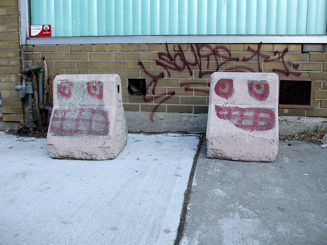 Faces on concrete barriers in Kensington Market