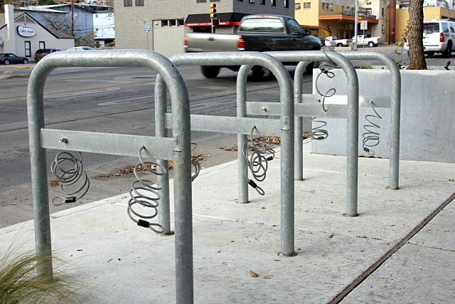 Bike racks with integrated cable locks